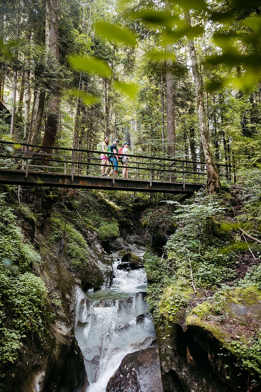 Wanderer auf Brücke in der Hausbachklamm bei Weiler im Allgäu