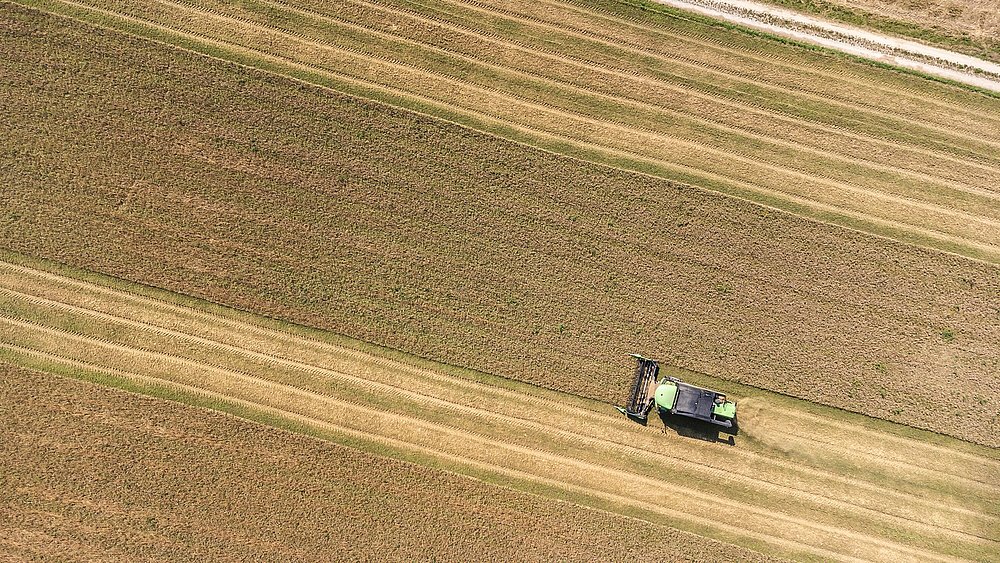 Eine Landmaschine beim ernten aus der Vogelperspektive