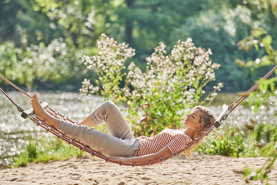 Frau entspannt in einer Hängematte im Kurpark von Bad Wörishofen