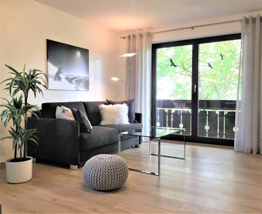 Modernes gemütliches Wohnzimmer mit Essplatz und Zugang zum großzügigen Südbalkon.