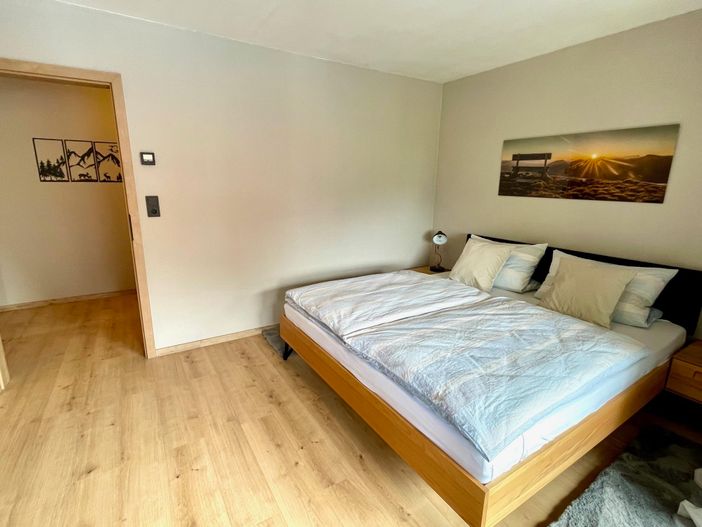 Doppelbett mit Blick in den Umkleideraum